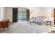 Living room featuring neutral carpet and sliding glass doors at 13500 E Cornell Ave # 302, Aurora, CO 80014