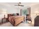 Bright bedroom with floral bedding and ceiling fan, complemented by natural light from the window at 13934 W Warren Dr, Lakewood, CO 80228