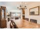 Dining area with a large table, chandelier, and seamless flow into the living room, perfect for entertaining at 13934 W Warren Dr, Lakewood, CO 80228