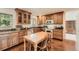 Eat-in kitchen featuring warm wood cabinetry, modern appliances, and a functional layout for cooking and dining at 13934 W Warren Dr, Lakewood, CO 80228