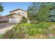 Two-story home featuring an attached garage and complemented by a vibrant and beautifully landscaped front yard at 13934 W Warren Dr, Lakewood, CO 80228