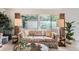 Bright living room featuring large windows, comfortable seating, and ample natural light at 13934 W Warren Dr, Lakewood, CO 80228