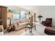Bright and airy living room offering comfortable seating, large windows, and a welcoming atmosphere at 13934 W Warren Dr, Lakewood, CO 80228