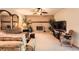 Cozy living room featuring a brick fireplace, ceiling fan, neutral carpet, and comfortable seating at 13934 W Warren Dr, Lakewood, CO 80228