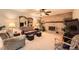 Inviting living room featuring a brick fireplace, ceiling fan, and comfortable seating at 13934 W Warren Dr, Lakewood, CO 80228