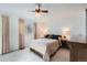 Bright bedroom with soft carpet, a ceiling fan, and natural lighting at 13934 W Warren Dr, Lakewood, CO 80228