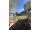Backyard with a partial stone paver path, grass, storage shed, and partial fence at 253 7Th St, Frederick, CO 80530