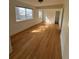 Inviting living room featuring beautiful hardwood floors and large windows, creating a warm, sun-lit atmosphere at 253 7Th St, Frederick, CO 80530