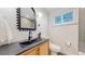 Modern bathroom with black vanity and fixtures at 7195 W 24Th Ave, Lakewood, CO 80214