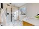 Bathroom with hexagon tile shower and vanity at 7195 W 24Th Ave, Lakewood, CO 80214