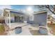 Rear view of the house showcasing the patio and landscaping at 7195 W 24Th Ave, Lakewood, CO 80214