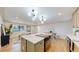 Modern kitchen with a large island, updated appliances, and light-toned cabinetry at 7195 W 24Th Ave, Lakewood, CO 80214