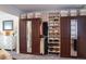 Large walk-in closet with double mirrored doors and custom shelving at 12838 W Iliff Ave, Lakewood, CO 80228