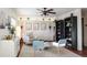 Cozy sitting room featuring a ceiling fan, comfy armchairs, and built-in shelving at 12838 W Iliff Ave, Lakewood, CO 80228