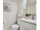 Bright bathroom with a white vanity, modern fixtures, and stylish framed art at 1251 S Yosemite Way # 92, Denver, CO 80247