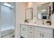 Bright bathroom featuring dual sinks, white cabinets, and walk-in shower at 1251 S Yosemite Way # 92, Denver, CO 80247
