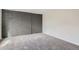 Bedroom with gray brick accent wall, neutral carpet, and bright natural light at 1251 S Yosemite Way # 92, Denver, CO 80247