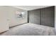 Bright bedroom with neutral carpet, window, and exposed grey brick wall at 1251 S Yosemite Way # 92, Denver, CO 80247