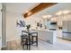 Contemporary kitchen featuring a breakfast bar, stainless steel appliances, and modern lighting at 1251 S Yosemite Way # 92, Denver, CO 80247