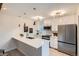 Contemporary kitchen with white cabinetry, stainless steel appliances, and stylish pendant lighting at 1251 S Yosemite Way # 92, Denver, CO 80247