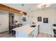 Bright kitchen with white cabinets, a beam, stainless steel appliances, and modern lighting at 1251 S Yosemite Way # 92, Denver, CO 80247