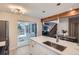 Open kitchen with stainless steel appliances, white countertops, and access to the outdoor patio at 1251 S Yosemite Way # 92, Denver, CO 80247
