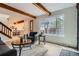 Living room featuring wood beams, staircase, large window, and modern decor at 1251 S Yosemite Way # 92, Denver, CO 80247