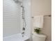 Close-up of the bright white tiled shower with updated hardware and fixtures at 1251 S Yosemite Way # 92, Denver, CO 80247