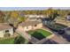 An aerial view showcasing a charming single-Gathering home with a well-kept lawn at 709 S Wolcott Ct, Denver, CO 80219