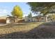 Large backyard showing the shed converted to an office, the back of the house and shed at 709 S Wolcott Ct, Denver, CO 80219
