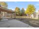 Open backyard with a covered patio and a spacious lawn, perfect for relaxation or entertainment at 709 S Wolcott Ct, Denver, CO 80219