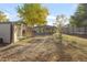 A spacious backyard featuring a lawn, shed, and patio area, perfect for outdoor enjoyment at 709 S Wolcott Ct, Denver, CO 80219