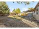 Expansive backyard with a mix of greenery, a patio area, shed and privacy fence at 709 S Wolcott Ct, Denver, CO 80219
