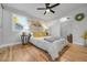 Bedroom featuring a ceiling fan, natural light, and a large closet at 709 S Wolcott Ct, Denver, CO 80219