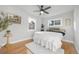 Bedroom with hardwood floors, two windows, and a white rug at 709 S Wolcott Ct, Denver, CO 80219