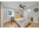 Comfortable bedroom with hardwood floors, stylish decor, and a ceiling fan at 709 S Wolcott Ct, Denver, CO 80219