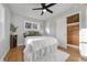 Bedroom features a ceiling fan and white comforter, adjacent to a closet at 709 S Wolcott Ct, Denver, CO 80219