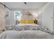 Bedroom featuring a bed with yellow pillows and modern art hanging above at 709 S Wolcott Ct, Denver, CO 80219