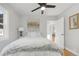 Sunlit bedroom boasts hardwood floors, a ceiling fan, and a doorway at 709 S Wolcott Ct, Denver, CO 80219