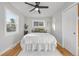 Bedroom features a ceiling fan and white comforter, illuminated by a window at 709 S Wolcott Ct, Denver, CO 80219