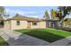 Charming single-story home with a well-manicured lawn and classic design at 709 S Wolcott Ct, Denver, CO 80219