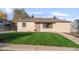 Charming single-story home with well-maintained lawn and a cozy front porch at 709 S Wolcott Ct, Denver, CO 80219