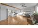 Open concept living room and kitchen featuring hardwood floors and natural lighting at 709 S Wolcott Ct, Denver, CO 80219