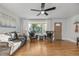 Cozy living room area with comfortable seating, hardwood floors, and a large window at 709 S Wolcott Ct, Denver, CO 80219