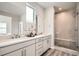 Bright primary bathroom with double sink vanity, natural light and glass shower at 959 Promenade Dr, Superior, CO 80027