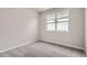 Neutral bedroom with large bright window, light-gray carpet and minimal design at 959 Promenade Dr, Superior, CO 80027