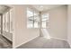 A bright, carpeted bedroom features natural light from two windows, creating a serene atmosphere at 959 Promenade Dr, Superior, CO 80027