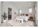 Relaxing bedroom featuring a decorative carpet, a queen bed and access to an ensuite bathroom at 959 Promenade Dr, Superior, CO 80027