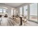 Bright dining room with large windows, modern table and chairs, and stylish gray wood flooring at 959 Promenade Dr, Superior, CO 80027