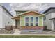 Charming two-story home with green siding, brick accents and white trim around large front windows at 959 Promenade Dr, Superior, CO 80027